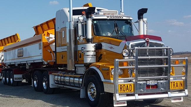 Wagners truck in front of pile of grey material