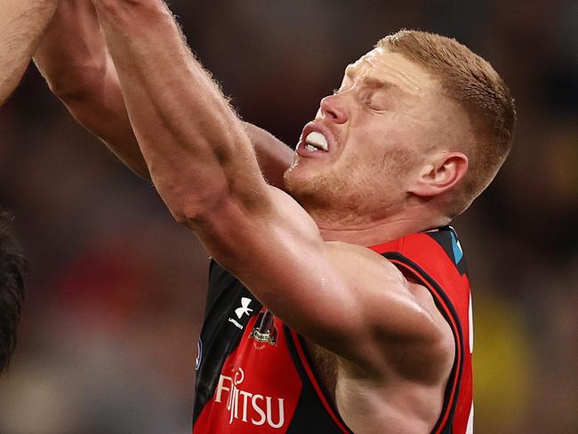 MELBOURNE . 20/08/2022. AFL. Round 23. Essendon vs Richmond at the MCG.   Richmonds Robbie Tarrant` does enough to spoil the ball away from Peter Wright of the Bombers    . Picture: Michael Klein