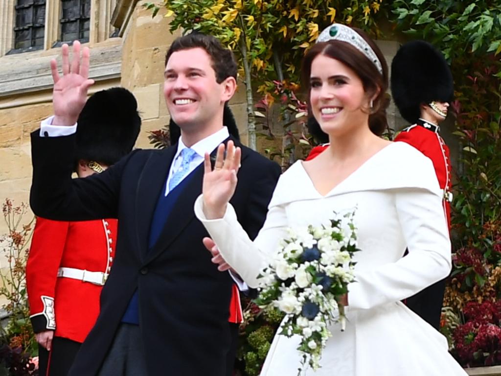 Princess Eugenie of York and husband Jack Brooksbank wave as they walk down the West Steps as they leave St George’s Chapel in Windsor Castle following their wedding on October 12, 2018 in Windsor, England. (Photo by Victoria Jones - WPA Pool/Getty Images)