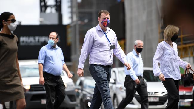 People wear masks as they walk through central Brisbane. Picture: NCA NewsWire / Dan Peled