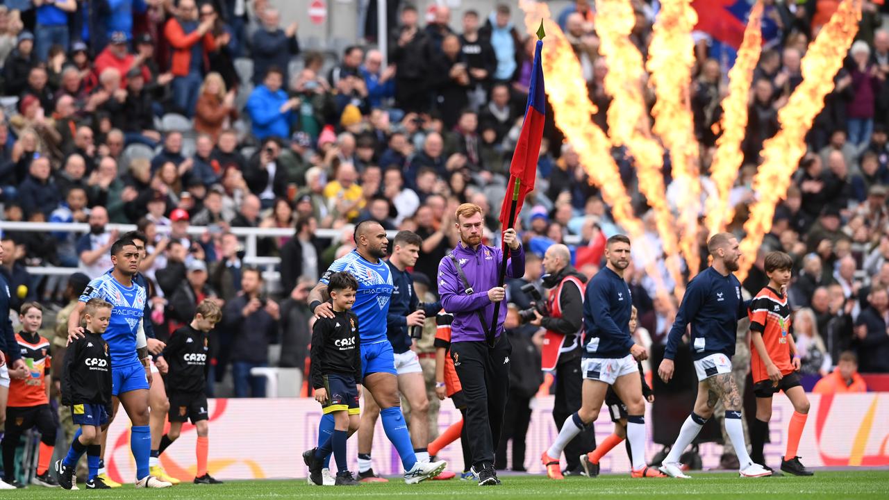 The two teams make their way onto the field. Photo by Stu Forster/Getty Images