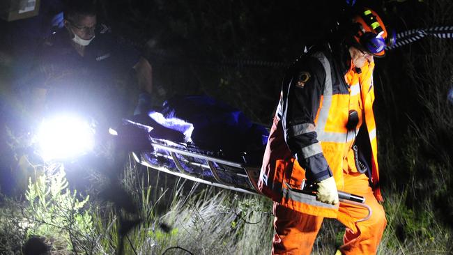 The remains of Dale McCauley are removed from scrub near Second Valley. Picture: Mark Brake