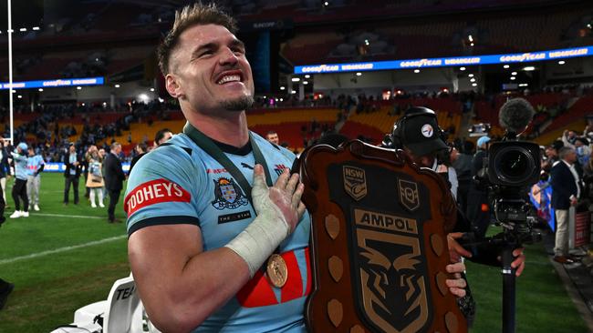 BRISBANE, AUSTRALIA - JULY 17: Angus Crichton of the Blues poses with the State of Origin Shield after winning the series 2-1 after game three of the 2024 Men's State of Origin series between Queensland Maroons and New South Wales Blues at Suncorp Stadium on July 17, 2024 in Brisbane, Australia. (Photo by Bradley Kanaris/Getty Images)