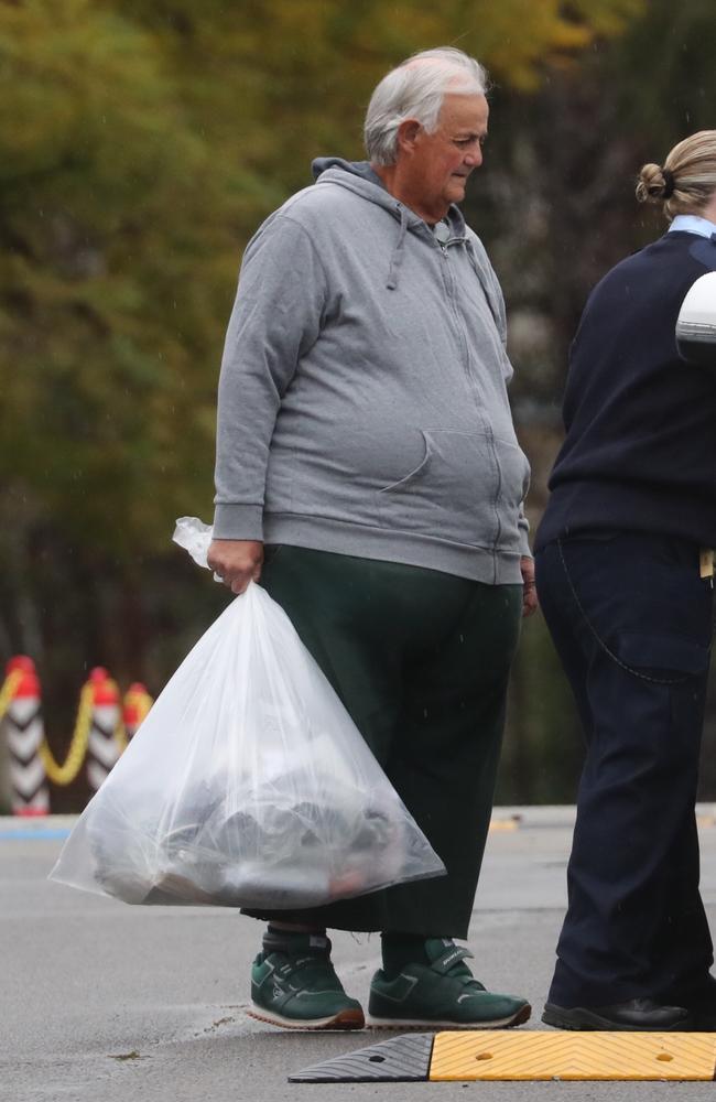 He carried a plastic bag of his possessions into the waiting van. Picture: John Grainger