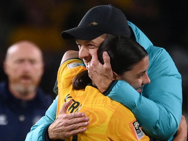 Australia's coach Tony Gustavsson (R) greets Australia's forward #20 Sam Kerr at the end of the Australia and New Zealand 2023 Women's World Cup round of 16 football match between Australia and Denmark at Stadium Australia in Sydney on August 7, 2023. (Photo by FRANCK FIFE / AFP)