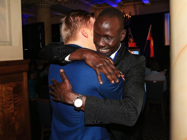 Award recipient Deng Adut runs and hugs Paul Hicherson, a long-time friend who Deng hadn't seen in 10 years. Picture: Toby Zerna