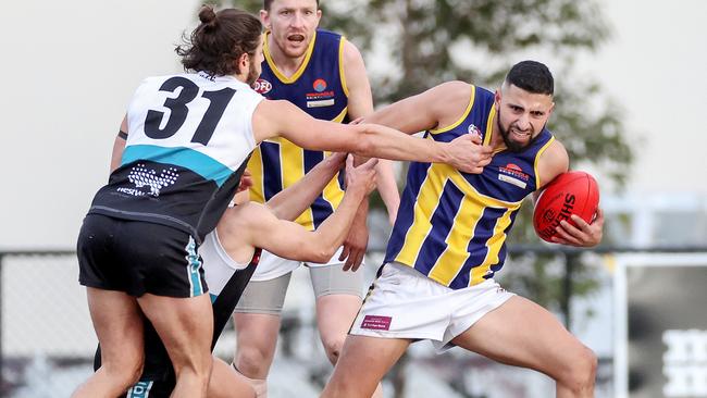 EDFL: Rupertswood’s Matthew Italiano is tackled by Nicholas Karakyriakos and Zac Dicianni of Hillside. Picture: George Salpigtidis