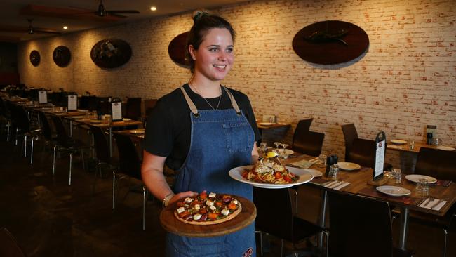 Rustic Olive’s Emily Clooney carries a Donatello Pizza and Spaghetti Anchovies with Barramundi Fillet. Picture AAP/ David Clark