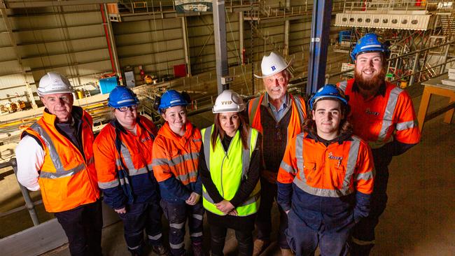 L-R: Incat Strategic Adviser Peter Gutwein, Apprentices Sarah Thomson and Carys Lavia, Senator Jacqui Lambie, Incat Chairman Robert Clifford, and apprentices Joel Bresnehan and Adrian Sheldrick above Wilsons dock at Incat, where a 130 metre ship is under construction.Picture: Linda Higginson