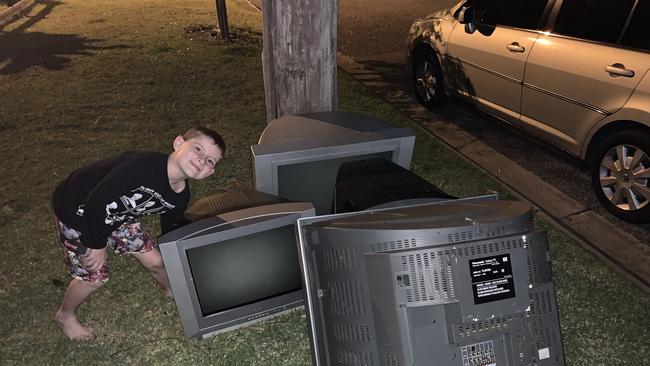 Mr Cowan says Facebook must not care about their customers based on his experiences. Pictured: His son collecting TVs to repair.