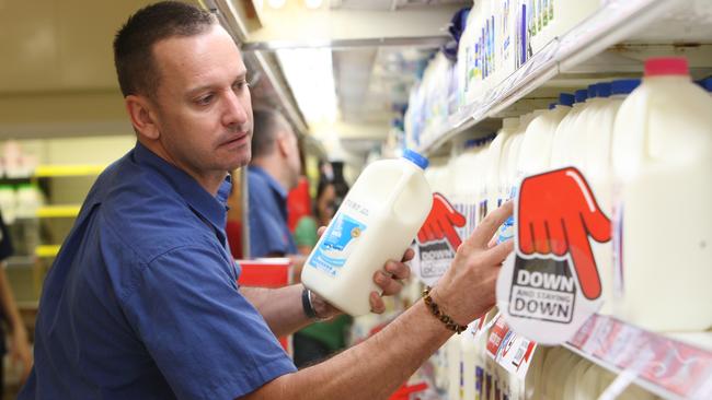 Coles milk goes on the shelves at  $2  for 2 litres. Paul Taylor stocking up the shelves.