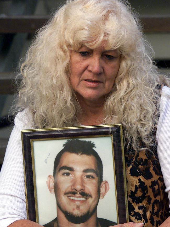 Pam Walsh holds a photo of her son Jason Tyler.