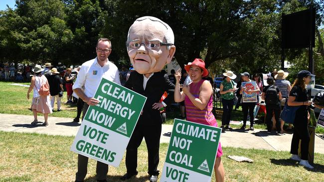 Greens MPs David Shoebridge and Jenny Leong pose for a photo with a protester dressed as Prime Minister Scott Morrison. Picture: Joel Carrett