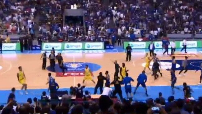 The Australian bench tries to enter the brawl, but they are stopped as Luc Longley goes the the defence of Kickert