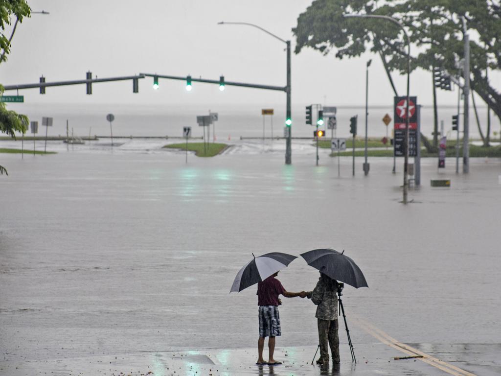 In this 2018 photo, people stand near flood waters from Hurricane Lane in Hilo, Hawaii. Some of Hawaii could soon be underwater. Picture: Hawaii Tribune-Herald/AP