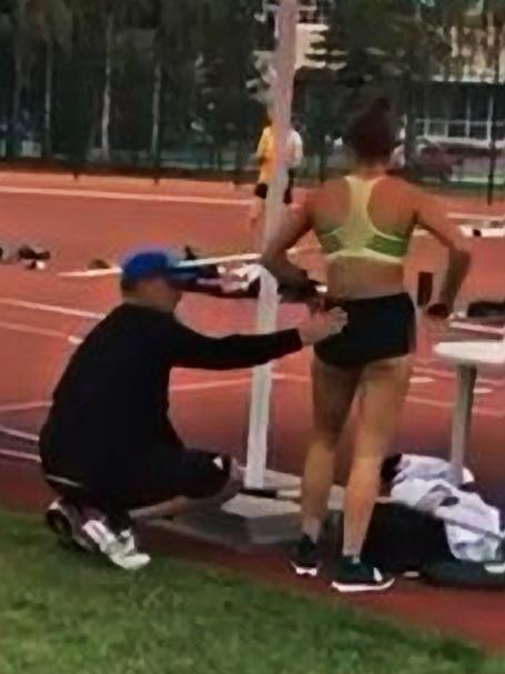 Still from a video posted to Instagram showing coach Alex Parnov stroking the bottom of Olympic pole vaulter Nina Kennedy.