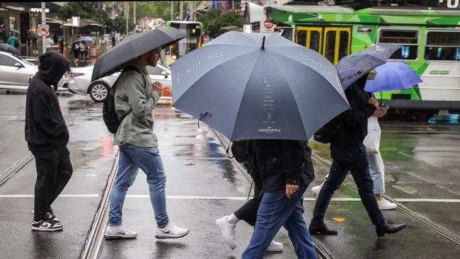 Heavy rainfall fell across the Melbourne CBD area this morning as the temperature is forecast to drop. Picture: Ian Currie