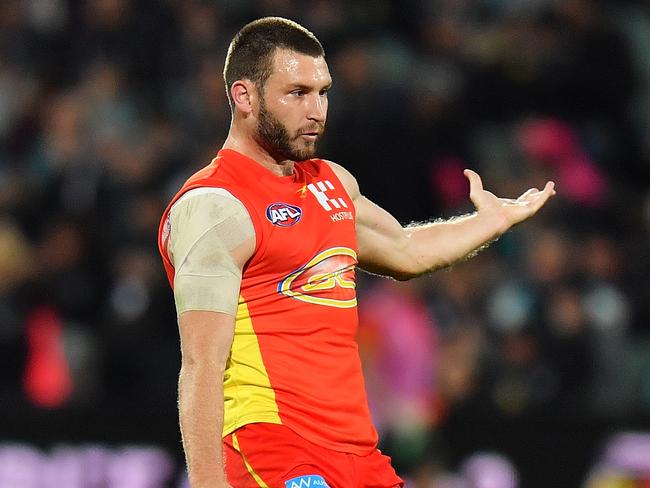 Mitch Hallahan takes a kick for the Gold Coast Suns.