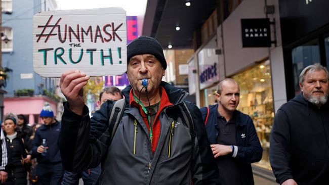 A protester holds up a placard as he takes part in an anti-lockdown protest. Picture: AFP