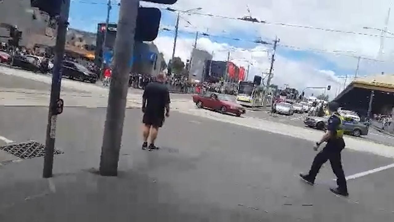 A car stops traffic on Flinders St   