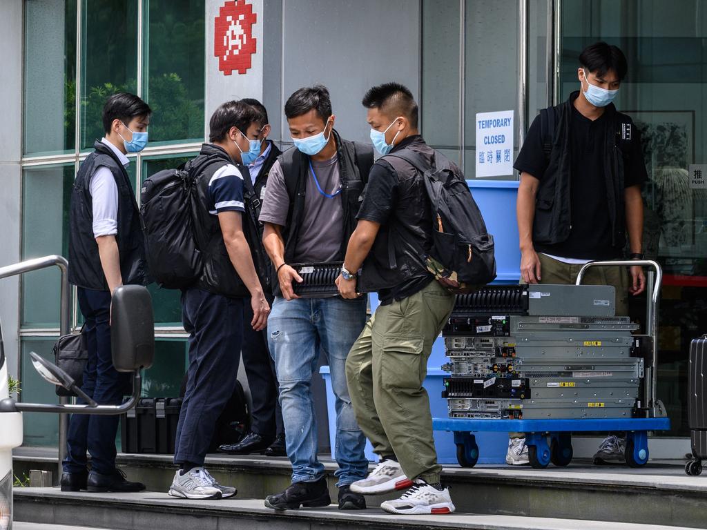 Computer equipment is taken by police to a waiting vehicle from the offices of the local Apple Daily newspaper in Hong Kong.