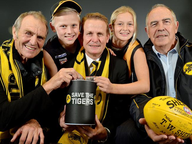 Glenelg Football Club legend Graham Cornes, fan Joe Chigwidden (11), club president Nick Chigwidden, fan Summer Ryan (12), & Club legend Peter Carey at the launch of the club's 'Save the Tigers' fund. Pictured at Phil Hoffman travel, Glenelg.picture: Bianca De Marchi