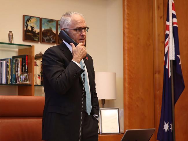 Australian Prime Minister Malcolm Turnbull talking on the telephone to US President-elect Donald Trump in his office in Canberra..