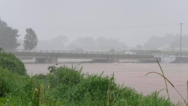 A car crossing the John Muntz Bridge in Upper Coomera on February 13, 2020, after heavy rain caused the Coomera River to rise. Picture: Mark Boothman / Facebook