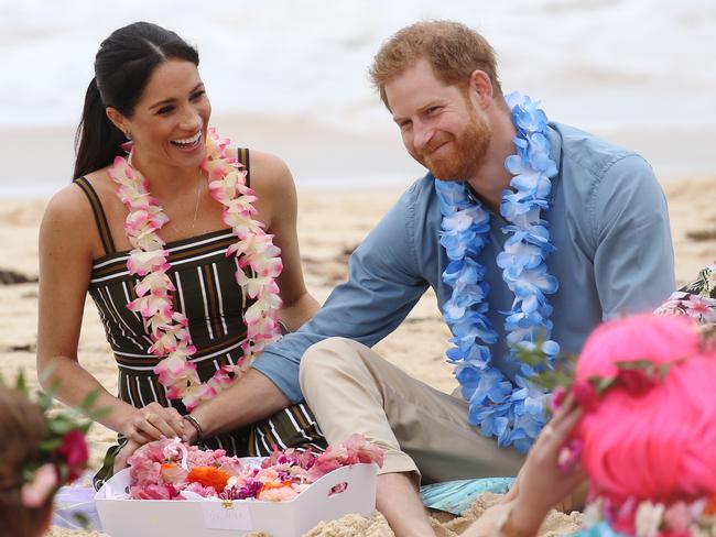 The Duke and Duchess of Sussex, Prince Harry and Meghan Markle visit Bondi beach to take part in the "Fluro Friday" yoga session. Members of the "Anti Bad Vibe Circle" sit on the sand  with the royal couple. Picture: Toby Zerna