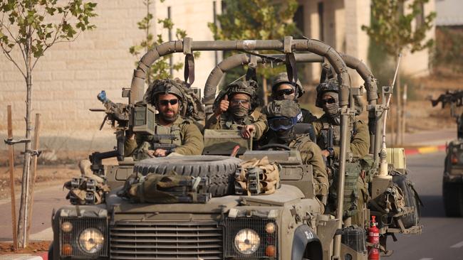 Israeli troops move near the border with Gaza on Saturday. Picture: Dan Kitwood/Getty Images