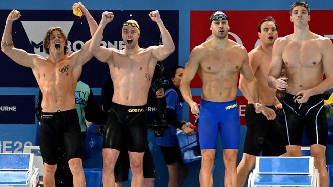 The Australian team (L) celebrate winning the gold medal as members of the Italian team look on, in the Men's 4x50m Freestyle final at the FINA World Swimming Championships (25m) 2022 in Melbourne on December 15, 2022. (Photo by William WEST / AFP) / -- IMAGE RESTRICTED TO EDITORIAL USE - STRICTLY NO COMMERCIAL USE --