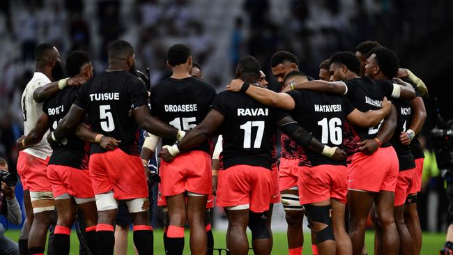 Fiji's players huddle after losing the Rugby World Cup quarter-final match against England. Picture: AFP