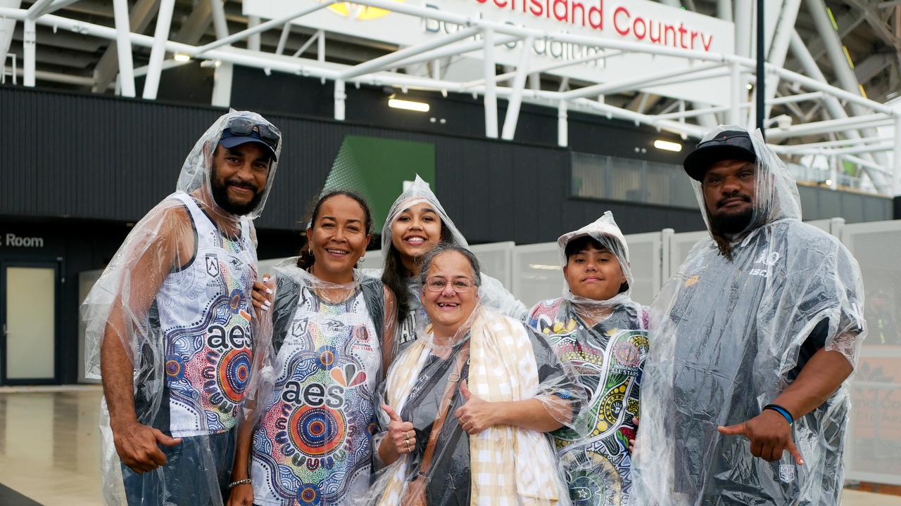 The Jia and Mcewan-Ware families had their ponchos ready to go on a wet night in Townsville. Picture: Blair Jackson