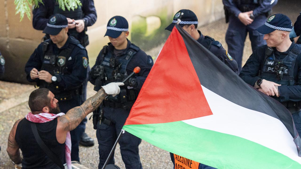 A protester is seen speaking to a strong police contingent outside Sydney’s Town Hall. Picture:NewsWire/ Monique Harmer