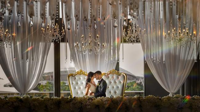 Nicole and Sam Viola married at Sacred Heart College, with a reception at EOS Sky City. Photographer: B Captured by Ky Luu