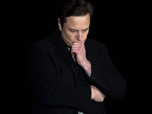 (FILES) In this file photo taken on February 10, 2022 Elon Musk pauses and looks down as he speaks during a press conference at SpaceX's Starbase facility near Boca Chica Village in South Texas. - Tesla Chief Executive Elon Musk courted dual controversies February 17, 2022, accusing a US regulator of trying to stifle his speech while drawing condemnation for comparing Canada's leader to Hitler. (Photo by JIM WATSON / AFP)