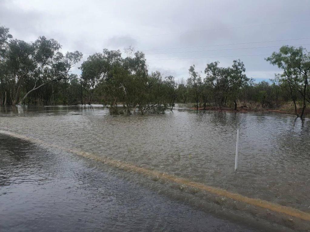 A flooded Creen Creek between Croydon and Normanton spills over the bridge. Picture: Hans Spinnler