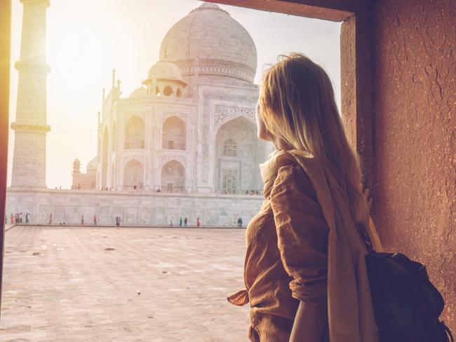 Young woman wandering around the famous Taj Mahal at sunset, Agra, India. Picture: iStockEscape, Rosamund Brennan, India