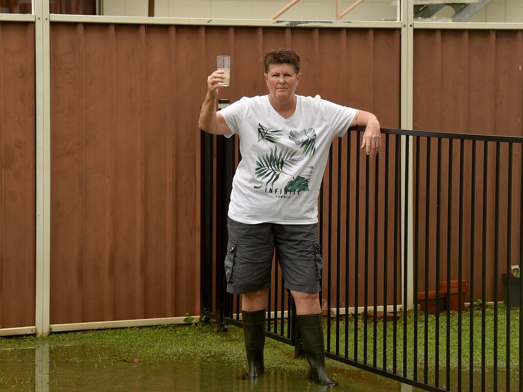 Leanne Dobbin stands in raw sewage flooding her backyard. Picture: Evan Morgan