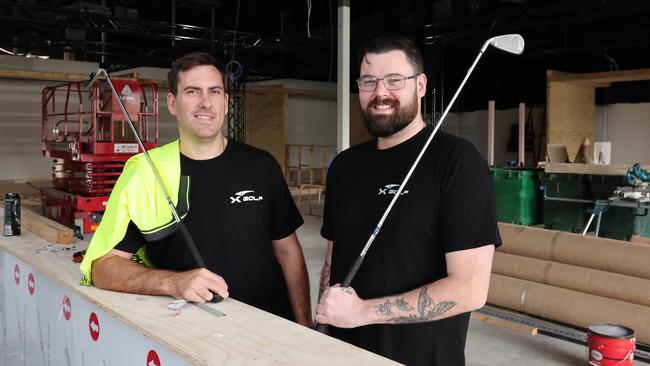 Two Ex-Army mates are taking a shot at the Gold Coast’s golfing scene, opening the city's first ever X-Golf franchise located at Ashmore. Owner Mitch Simkin and General Manager Alex Flori watching over the construction process. Picture Glenn Hampson