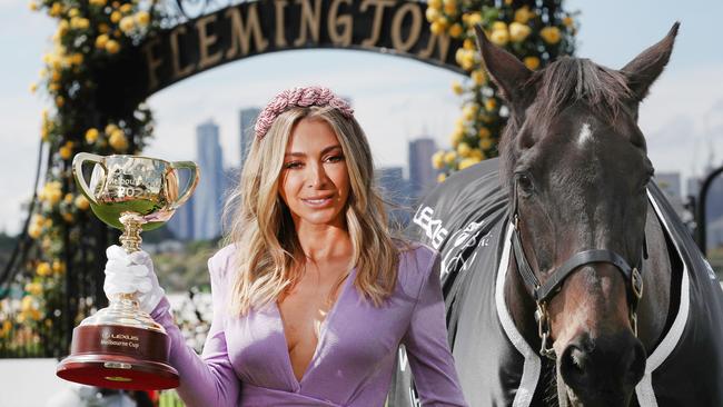 Melbourne Cup Carnival ambassador Nadia Bartel enjoys the sunshine with 2000 Melbourne Cup winner Brew at Flemington Racecourse. Picture: NCA NewsWire/David Crosling