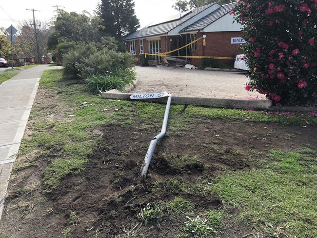 The car mounted a gutter and knocked over a road sign on its way to demolishing the waiting room wall.