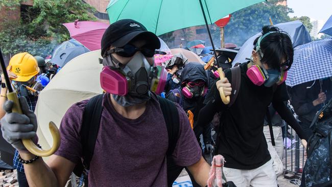 Protesters attempt to escape the campus of the Hong Kong Polytechnic University as Hong Kong riot police fire tear gas. Picture: AFP.