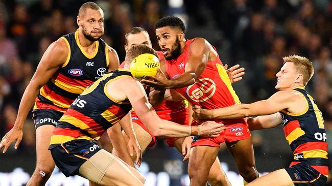 Touk Miller of the Suns handballs under pressure against Adelaide. Picture: Daniel Kalisz/Getty Images