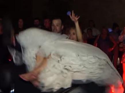 The bride and groom are suddenly thrown off the back of the car. Picture: YouTube