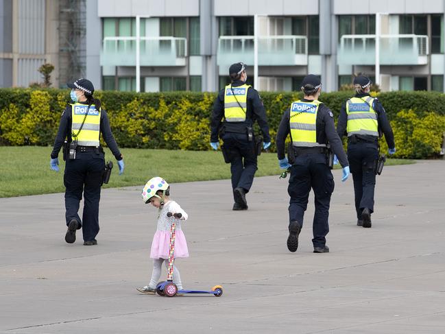 A girl plays on a scooter as police gather at the Shrine of remembrance in Melbourne on Sunday morning. Picture: NCA NewsWire / David Geraghty