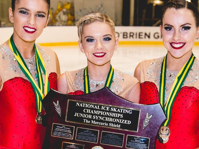 Bianca Douglas (centre) holds the national championship award with her team-mates Rachel Lynch and Georgia Duff. Picture: Chris Cao