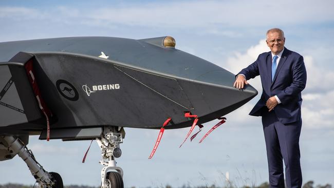 Prime Minister Scott Morrison with a Ghost Bat drone, while visiting RAAF base Amberley to announce the government will deliver major airfield works across four sites at RAAF Bases Amberley, Pearce, Richmond, and HMAS Albatross that will maintain critical airfield infrastructure.Picture: Jason Edwards