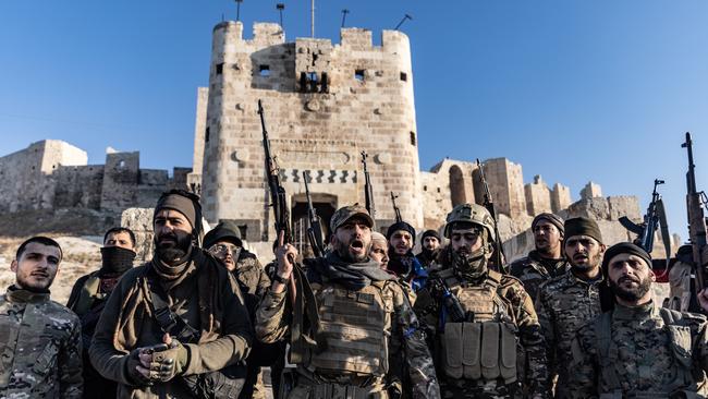 Members of the Syrian armed opposition forces stand in front of the ancient castle of Aleppo after seizing control of most parts of Syria's second largest city. Picture: Anas Alkharboutli/via Getty Images