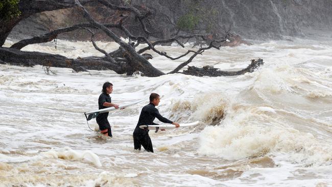 Surfers heads out into large waves and rough seas from Cyclone Gabrielle at Goat Island Marine Reserve. Picture: Fiona Goodall/Getty Images